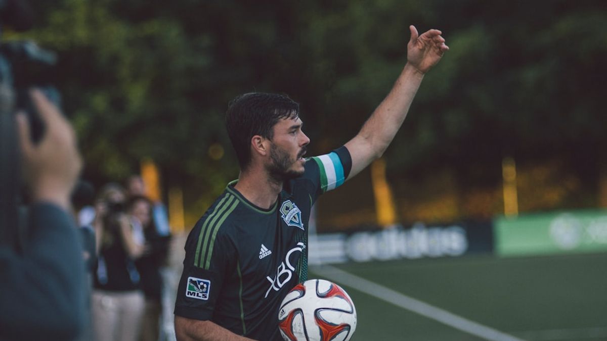 Persepolis FC players celebrating a goal with their fans in a packed stadium, symbolizing a new era for the club.