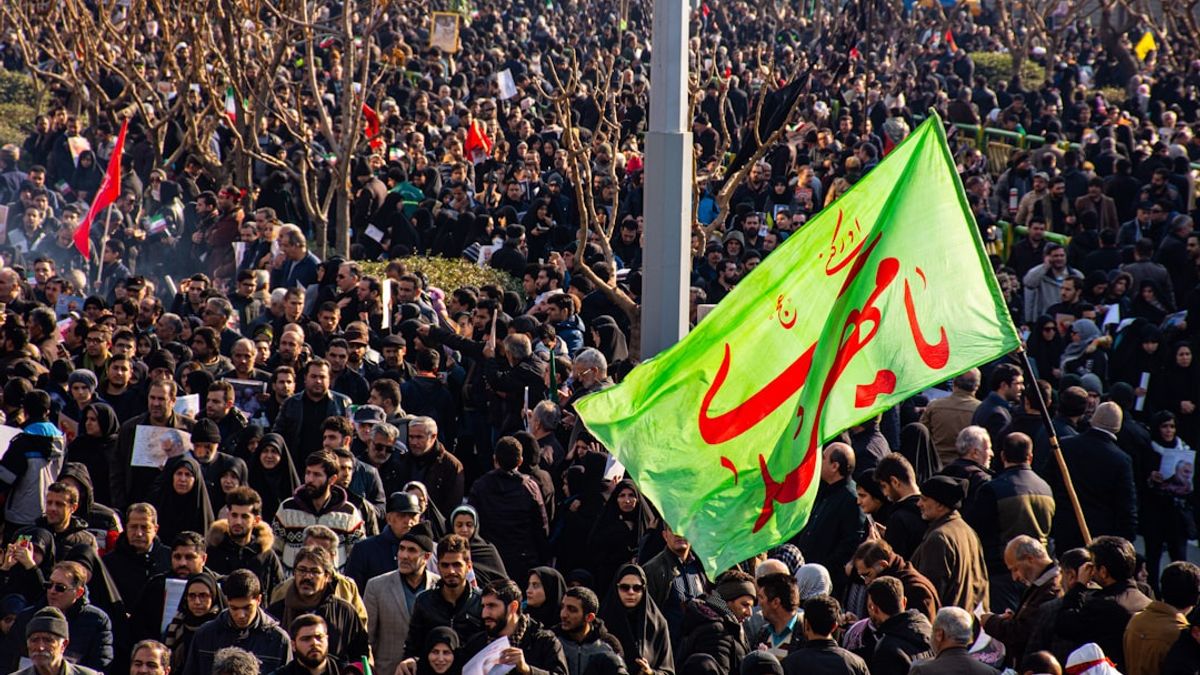 Team Melli players celebrating their qualification for the 2026 FIFA World Cup at Azadi Stadium, surrounded by jubilant fans.