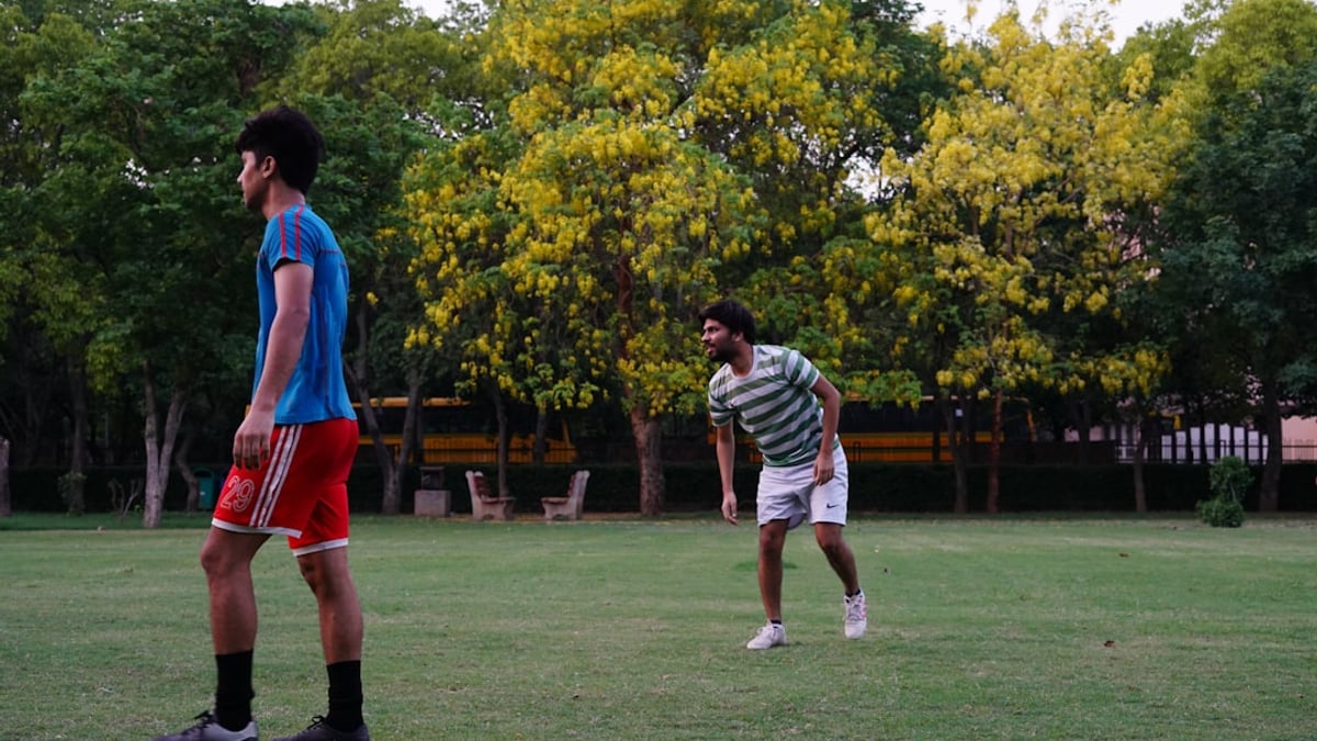A group of young Iranian football players training on a field, showcasing the next generation of talent.