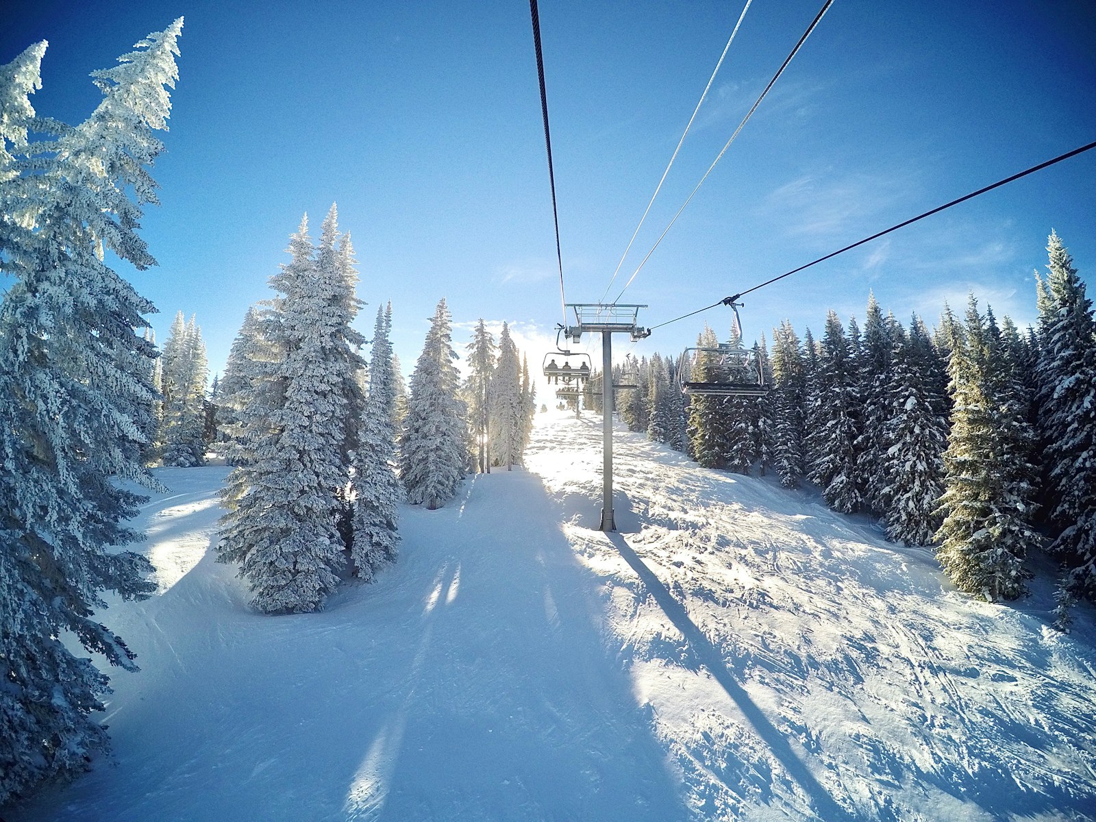 Ski lift with snow-covered Alborz peaks in the background