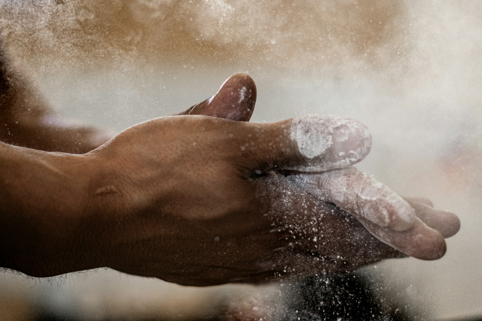 Alireza Moeini training in an Iranian weightlifting hall with chalked hands gripping the barbell