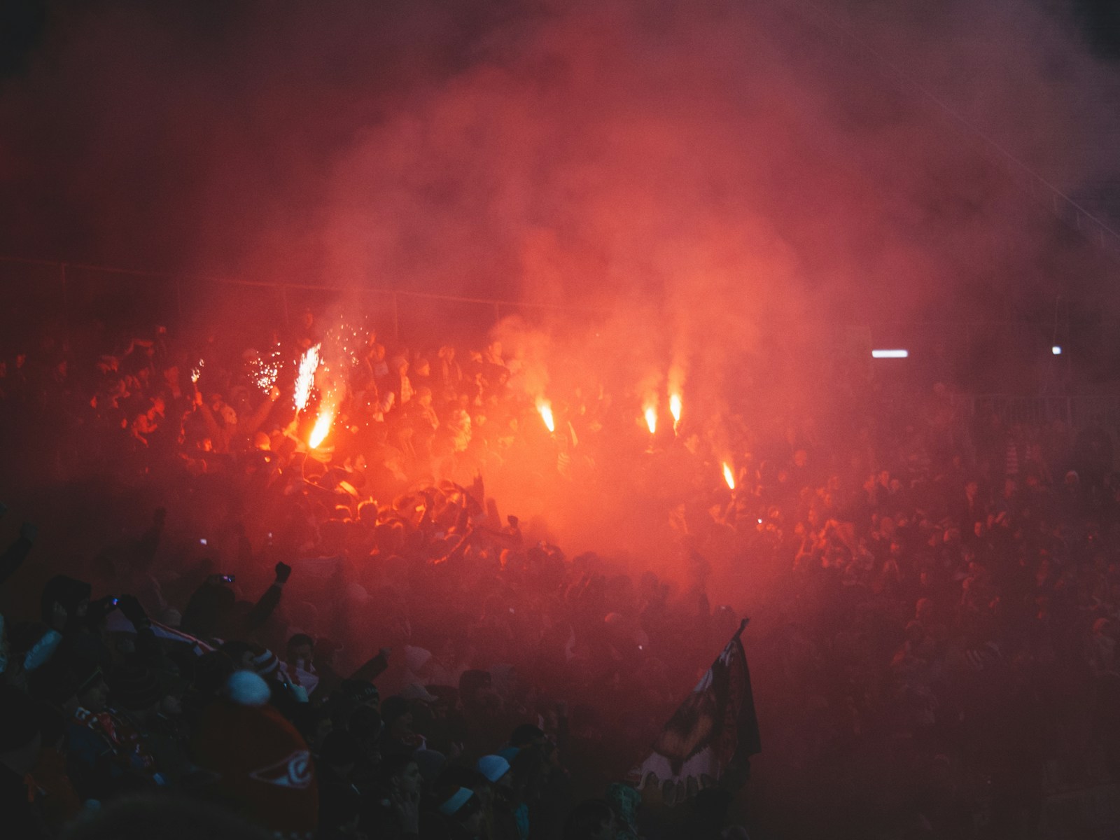 Azadi Stadium exterior on Tehran derby day with red and blue banners visible in the crowd