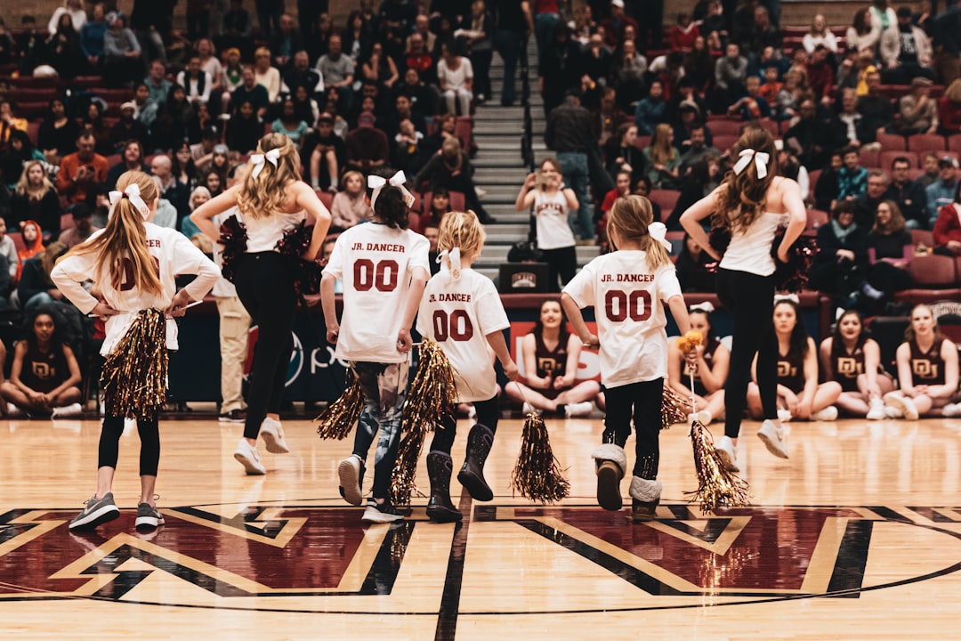 A women's basketball team celebrating a championship victory on the court