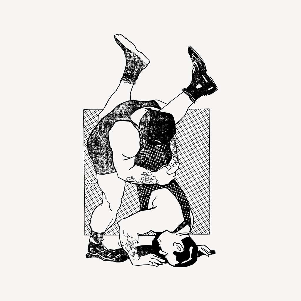 A pair of laced wrestling shoes resting on the surface of a competition mat