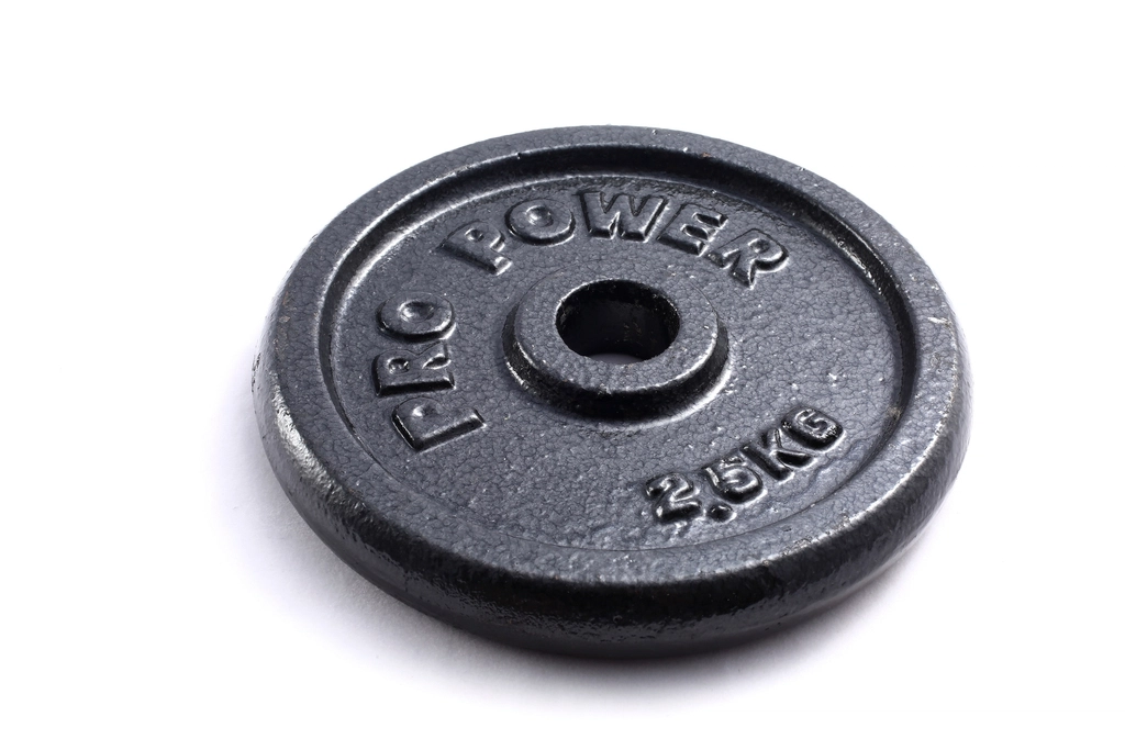 Large iron plates loaded on the end of a barbell with collars fastened in place